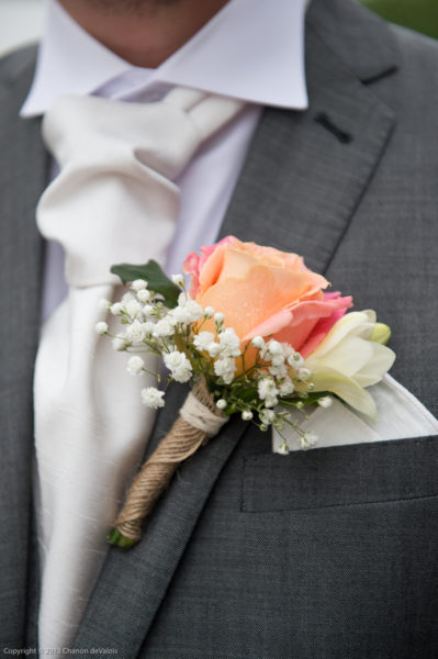 Groom's button hole with Miss Piggy Rose and Gypsophila