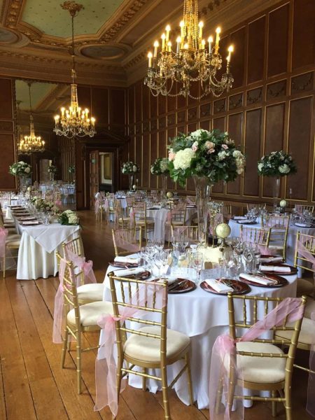 Tall vase table centrepieces at Gosfield Hall
